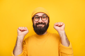 Excited hipster man in yellow