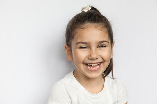 Portrait of happy cute brunette child  girl on white background
