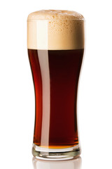 Mug of frosty dark beer with foam isolated on a white background