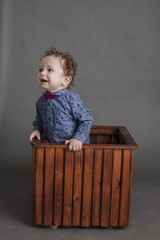 Boy inside box isolated inside studio