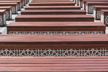 Rows of wooden benches in front of Blue Mosque Istanbul, Turkey. Background of rectangular chairs.