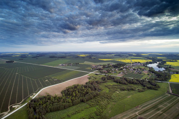 Aerial view of agricultural fields in summer evening, Latvia.