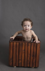 Boy inside box isolated inside studio