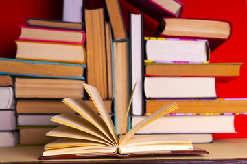 Open book, hardback books on bright colorful background.