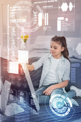 Clever child. Calm smart child carefully holding a stylus while working on a modern computer