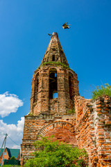 Ruins of the abandoned church of St. John the Evangelist of the 18th century in Fedorovsky. A nest of storks on the bell tower. Zhukovsky District, Kaluzhskiy region, Russias