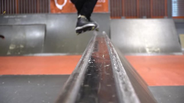 A man in a skate park makes a trick a cheese grater, slow motion, Niffty