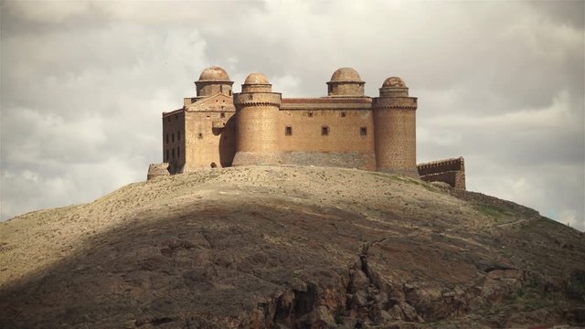 Birds flying over mountain top castle, high contrast light Calahorra Spain.mov