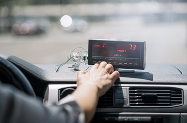 Woman's hand driving taxi machine.
