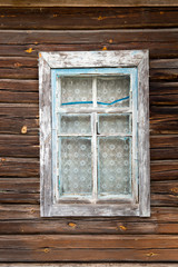 Simple blue Old wooden window on a wooden wall from an old lumber