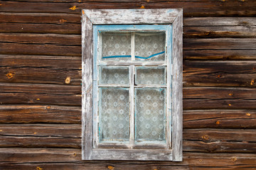 Simple blue Old wooden window on a wooden wall from an old lumber