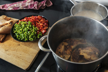 chicken fried in a pot to cook it with pepper