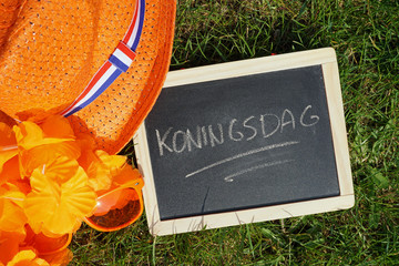 Kingsday written in Dutch on a chalkboard in a park