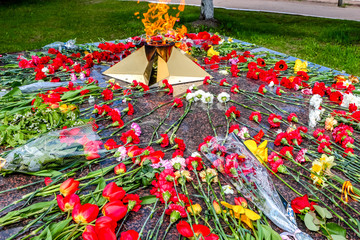 Eternal flame with flowers in memory of the victims of the Great Patriotic War 1941-1945, Russia
