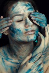 portrait of a girl with blue and white watercolor on her face