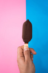 hand holding a chocolate and mint ice cream.