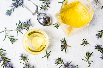 Rosemary tea with fresh plant and blossom