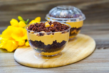 Lilac cake covered with chocolate and peanuts