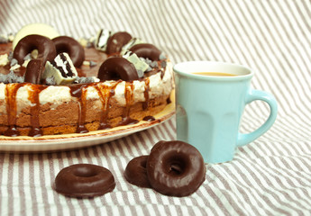Homemade cake three chocolates with cup of coffee. Mousse glaze darkness decoration cake.