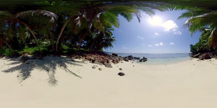 360 degree view 4k video deserted small beautiful sand beach with palmtrees on seychelles island on sunny day, recorded in 8K
