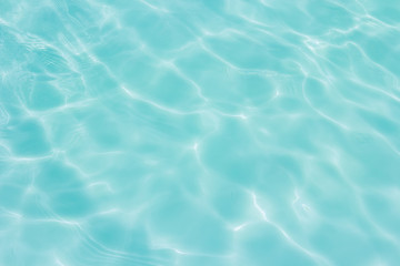 Fototapeta na wymiar Blue swimming pool with sunny reflections