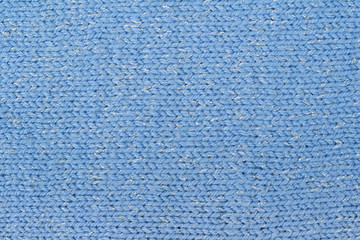 Sweater or scarf fabric texture large knitting. Knitted jersey background with a relief pattern. Wool hand- machine, handmade.