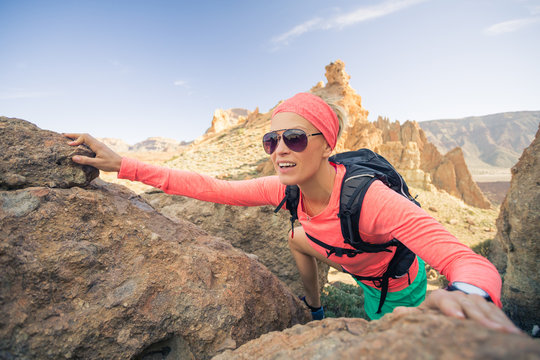 Woman hiker reached mountain top, backpacker adventure
