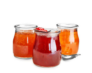 Fototapeta na wymiar Three jars with tasty sweet jam on white background