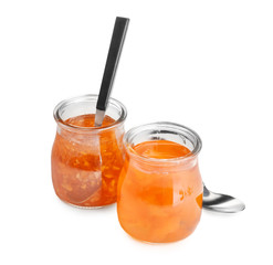 Two jars with tasty sweet jam on white background