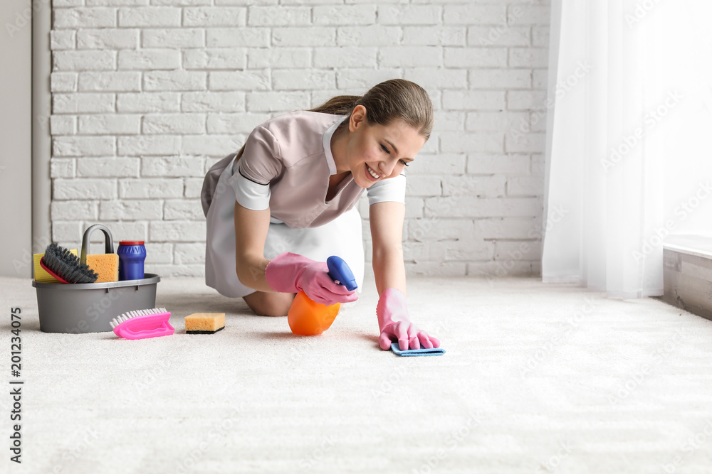 Poster Chambermaid woman cleaning carpet indoors