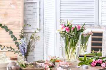 Fototapeta na wymiar Decorator's workplace with beautiful flowers on table