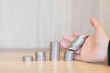 Close up of businesswoman hands with stack coins - stock and market down