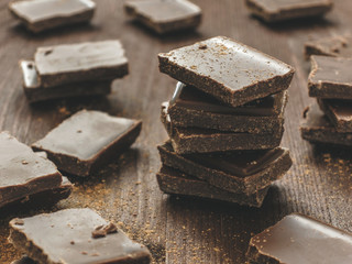 Dark chocolate stack on wooden background