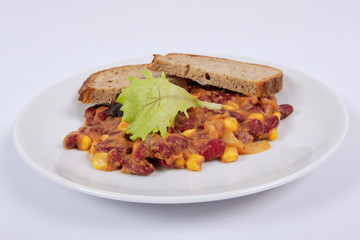 Cowboy beans with bread on a white