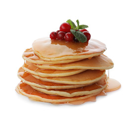Tasty pancakes with honey and berries on white background