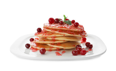Plate with delicious pancakes on white background