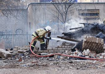 rescuers extinguish a debris