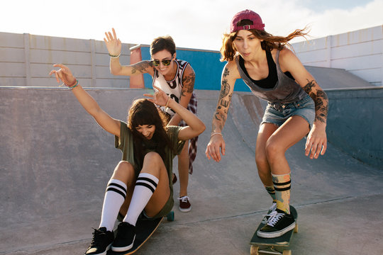 Group of women riding skateboards at skate park