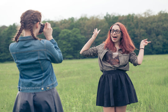 Two young hipster girl friends together having fun. Outdoors, lifestyle.
