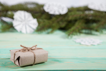 Gift box wrapped kraft paper tied with twine and paper snowflake and tied with twine. with copy space