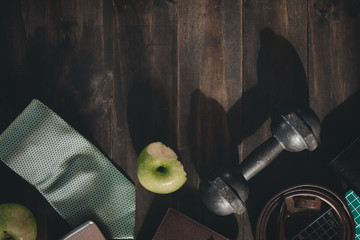 Men healthy active lifestyles concept. healthy fruits and active lifestyles, dumbbells, apples, neckties and gentleman accessories on wood background. Top view with copy space. vintage retro tone.