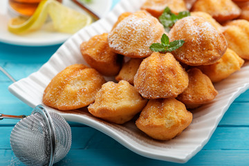 Madeleine - homemade traditional French small cookie on light blue background.