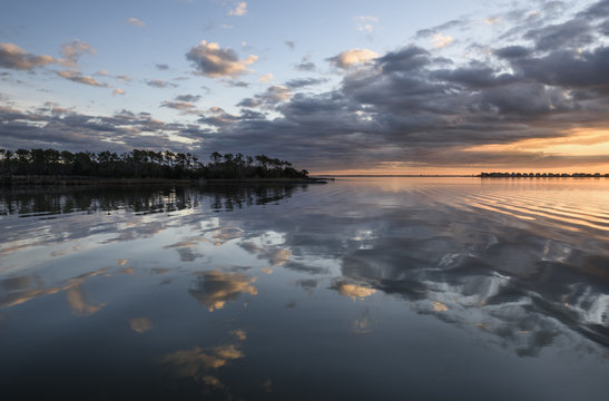 Dramatic Clouds Reflecting in Smooth Water at Sunrise - Outer Banks, North Carolina