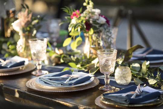 Vintage table setup for outdoor wedding reception.