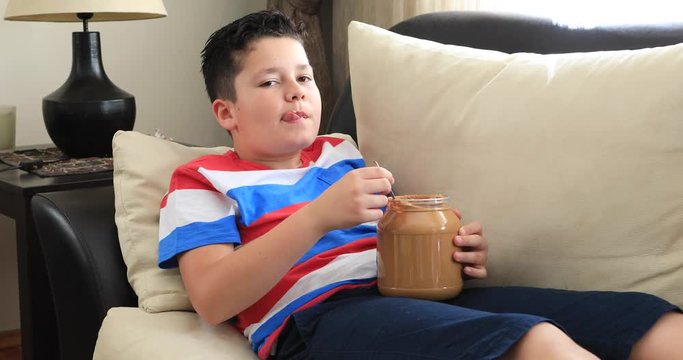 Painful preteen boy having abdominal pain, eating too much peanut butter at home