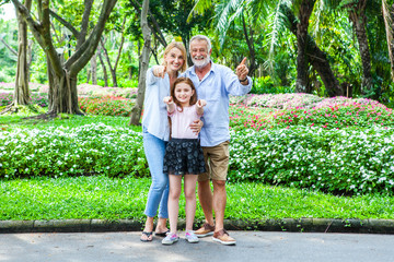 Fototapeta premium Portrait of happy family grandparent with granddaughter Family in park happiness concept.