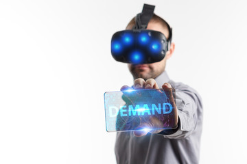 Business, Technology, Internet and network concept. Young businessman working in virtual reality glasses sees the inscription: Demand