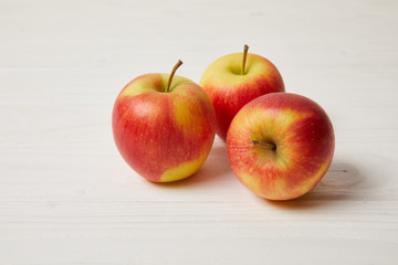 raw organic apples on wooden surface