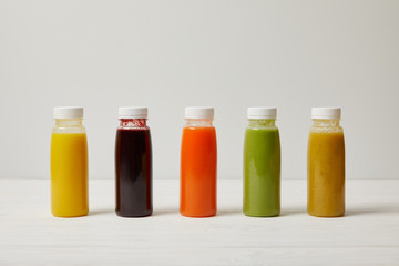 Fototapeta na wymiar detox smoothies in bottles standing in row, refresh concept