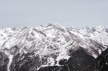 Alpine landscape and snow-capped peaks. Lots of mountains and cloudy sky